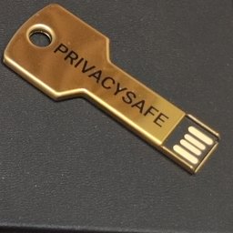 A brass key-shaped USB drive engraved PRIVACYSAFE